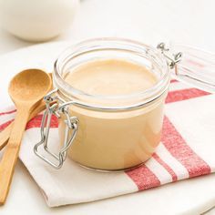 a glass jar filled with liquid sitting on top of a red and white towel