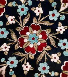 a close up view of a flower design on a black background with red, white and blue flowers