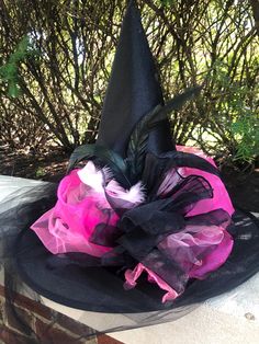 Beautiful witch hat has a very elegant Parisian style with various pinks and black tulle and organza all around. Long black tulle train cascades in the back to finish this unique hat.  One size fits most head circumferences up to 23 inches.  Other colors are possible. Please inquire for more information. Pink Witch Hat, Witches Night, Witches Night Out, Pink Witch, Tulle Train, Beautiful Witch, Holiday Costumes, Witch Fashion, Puff Dress