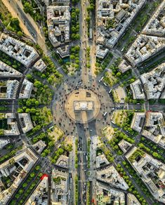 an aerial view of a city with lots of buildings and trees in the middle of it