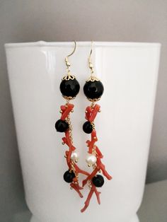 Baroque style earrings made of: - Faceted Onyx stones (10 mm), black color; - Faceted Onyx stones (8 mm), black color; - Natural Coral branches, red color; - Brass chain; - Gold plated Sterling Silver 925 hooks. Lenght : 10,5 cm / 4,13 inches These earrings are made with the utmost care and the utmost commitment to the technique, after a careful and meticulous research of the materials. The end result is a unique craftsmanship product and certainly different from its possible replication, given Elegant Red Coral Dangle Earrings, Elegant Red Earrings With Black Beads, Elegant Red Coral Jewelry With Matching Earrings, Elegant Red Coral Earrings, Elegant Red Coral Jewelry With Natural Stones, Black Natural Stone Dangle Earrings, Long Chain Earrings, Black Onyx Stone, Natural Coral