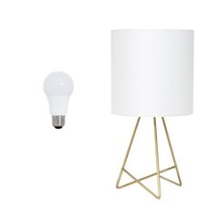 a lamp next to a white light bulb on a metal stand with a gold base