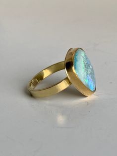 Stunning Australian Boulder Opal wrapped in a 22k Gold bezel sitting upon a wide 4mm 18k Gold band. This opulent ring is ready to make a statement on any finger!  The Opal is 17mm x 17mm. Size 6 3.4. Luxury Gold Opal Ring With Bezel Setting, Gold Rings With Bezel Setting, 22k Gold Ring, Boulder Opal Ring, Opal Band, Mixed Metal Earrings, Australian Boulder Opal, Etsy Gold Ring, 18k Gold Ring