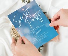 a person holding up a blue party card with the word sweet party written on it