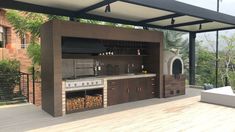 an outdoor kitchen with grill, sink and oven