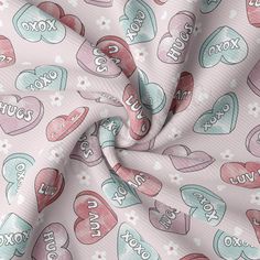 a pink fabric with hearts and words on it