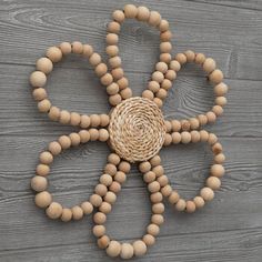 a wooden beaded necklace with a flower on it