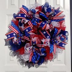 a patriotic wreath hanging on the front door