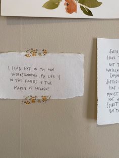 two pieces of paper taped to the wall next to each other with writing on them