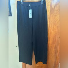 Eileen Fisher Black Pull On Pants Black Relaxed Fit Wide Leg Capris, Black Wide Leg Relaxed Fit Capris, Elegant Wide Leg Workwear Capris, Straight Leg Capris With Elastic Waistband For Work, Stretch Wide Leg Capris For Work, Elegant Wide Leg Capris For Workwear, Elegant Wide-leg Capris For Work, Black Relaxed Fit Ankle-length Capris, Black Straight Leg Capris With Pockets