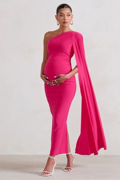 For a stunning maternity look that will always be remembered. take a look at our gracious Amaryllis gown. This pink bodycon dress is made from a premium stretch jersey that's double-lined for comfort and support. Finished with a sweeping cape sleeve and a split skirt. this asymmetric maxi dress deserves a place in your maternity wardrobe.Features - Premium stretch jersey- Asymmetric neckline- Single cape sleeve- Invisible zip closure- Bodycon fit- Bump ruching- Split hemline- Maxi lengthSizing & Fit Model is 5'8.5 and wears UK size 8 / US size 4True to size. please select your pre-pregnancy sizeProduct InformationDesigned exclusively by Club L LondonDouble layered with ultra stretchPremium jersey in Hot Pink (95% Polyester. 5% Elastane)140cm total lengthSKU: CL129202073 Mom To Be Dress Ideas, Elegant Maternity Bodycon Dress, Elegant Pink Maxi Maternity Dress, Elegant Pink Maxi Length Maternity Dress, Elegant Pink Maternity Gown, Pink Maxi Maternity Gown, Fitted Pink Maxi Maternity Dress, Elegant Evening Maternity Dress With Stretch, Elegant Pink Maternity Maxi Dress