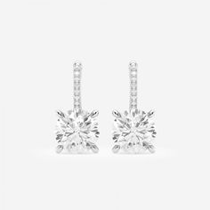 Badgley Mischka has always been the epitome of old Hollywood glamor, and nothing speaks to it more than these drop earrings. Round diamonds set in a classic four prong setting, dangle elegantly from a diamond studded lever back. Dazzling Formal Bridal Earrings With Pave Setting, Dazzling Bridal Earrings With Pave Setting For Evening, Diamond White Bridal Earrings With Pave Setting For Evening, Formal Diamond Bridal Earrings With Pave Setting, Classic Diamond Accented Earrings For Evening, Classic Diamond Bridal Earrings For Formal Occasions, Elegant Bridal Earrings With Brilliant Cut Platinum, Elegant Platinum Drop Bridal Earrings, Elegant Platinum Bridal Drop Earrings