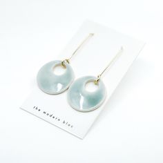 a pair of earrings sitting on top of a card