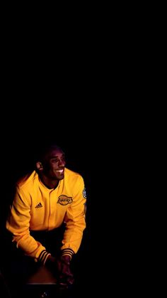 a man in a yellow jacket sitting down