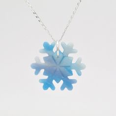 "These blue and white marbled snowflake necklaces are perfect for a Woman's Secret Santa Gift, or as a Stocking filler for her. They are handmade using polymer clay. I mixed up lots of different blue, translucent and pearly shades to give them an icy look. I also used a small amount of white glitter. Each snowflake necklace is unique and one of a kind, just like a real snowflake. I use high quality Sterling Silver jump rings and chain. The necklace chain is a beautiful 1mm diamond cut curb chain Blue Snowflake Sterling Silver Necklace, Winter White Sterling Silver Necklaces, White Snowflake Necklace For Gift, White Snowflake Jewelry For Gifts, White Snowflake Jewelry Gift, Sterling Silver Necklaces For Winter Gifts, Blue Christmas Jewelry For The Holidays, Winter Snowflake Necklace, Perfect For Gifts, Blue Jewelry Christmas Gift