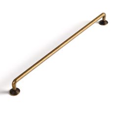 an antique brass pull handle on a white background