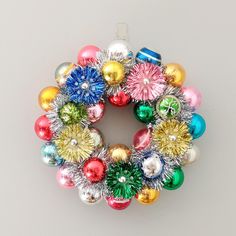 a colorful christmas ornament hanging on a white wall