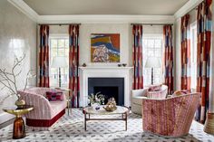 a living room filled with furniture and a fire place in front of a painting on the wall