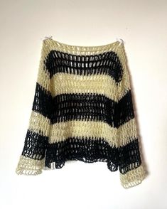 a black and white sweater hanging on a wall