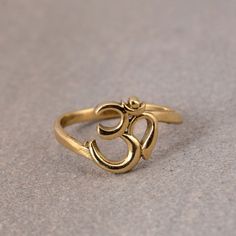 Solid Gold Om Ring, Yoga Ring, Ohm Jewelry, Yogini Ring, Spiritual Symbol Ring, Minimalistic Spirit Ring, Yoga Teacher Gift, Dainty Ring Gemstone: -Na Jewelery Category:- Handmade Ring Metal:- Brass -- T H E * Q U A L I T Y We buy raw gemstones directly from miners and then get them cut and polished at our workshop , Therefore saving some bucks (additional added fees and markups) avoiding a middle man and making sure of the authenticity of the gems. And we use top quality materials that are wate Spiritual Midi Rings As Gift, Spiritual Stackable Midi Rings Gift, Symbolic Brass Rings, Spiritual Style Open Midi Rings As Gifts, Gold Spiritual Stackable Toe Rings, Adjustable Symbolic Initial Ring, Spiritual Adjustable Stackable Midi Rings, Symbolic Adjustable Open Midi Rings, Symbolic Adjustable Midi Rings