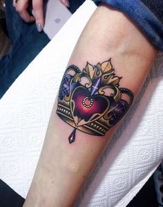 a tattoo with a crown on the arm