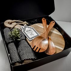 an open box with wooden utensils and napkins