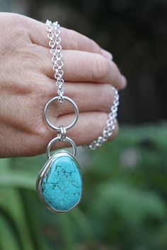 The most striking, one of a kind necklace featuring a natural turquoise cab surrounded by chunky sterling silver - what more could a boho babe ask for!? -d e t a i l s- -hand crafted & bezel set in solid sterling silver, this irregular turquoise cabochon measures 3 x 2.3 cm -the entire pendant incl. silver rings measures roughly 6cm top to bottom -includes a chunky 45cm sterling silver chain  Ready to ship! >All Lola&Cash jewellery will arrive gift wrapped >>Rush orders can be accommodated - ple Bohemian Turquoise Necklace In Sterling Silver, Bohemian Silver Necklace With Large Stone, Bohemian Sterling Silver Turquoise Gemstone Necklace, Bohemian Sterling Silver Necklace With Large Stone, Bohemian Turquoise Necklace With Large Sterling Silver Stone, Bohemian Silver Turquoise Necklace With Round Pendant, Bohemian Silver Turquoise Necklace With Gemstone, Sterling Silver Bohemian Necklace With Cabochon, Bohemian Sterling Silver Cabochon Necklaces