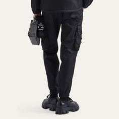 Prada pants in recycled-nylon  Regular rise Four-pocket style Leg pockets with buckles Skinny legs Full length Elastic hem  Nylon/polyamide Made in Italy Nylon Techwear Cargo Pants With Belt Loops, Techwear Nylon Pants With Belt Loops, Urban Nylon Cargo Pants With Belt Loops, Techwear Nylon Bottoms With Multiple Pockets, Functional Nylon Cargo Pants With Belt Loops, Techwear Nylon Pants With Functional Pockets, Nylon Techwear Pants With Multiple Pockets, Nylon Techwear Bottoms With Functional Pockets, Streetwear Nylon Pants With Functional Pockets