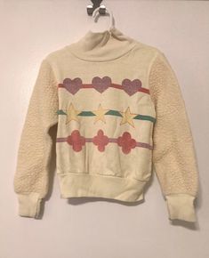 "Heart Sweatshirt - Girls Size 6X - Purple - Red - Yellow - Cream Green -Star - Clover - Sherpa Sleeve - Vintage 1980s 80s - Winter - Fall  I am in love with all the great 80s factors that make this an awesome style choice for today's kid.  The shapes, colors, and fabric combinations make this a winning look.   DESCRIPTION -Vintage from the 80s -Shirt maker is Doe-Spun Inc. -Size 6x kids (see dimensions below) -Hearts, stars, and clovers on a line graphic -Some light staining on edges of sleeves Vintage Graphic Print Winter Top, Fitted Vintage Long Sleeve Sweatshirt, Fitted Long Sleeve Vintage Sweatshirt, Retro Cream Top For Fall, Baby Tea, Line Graphic, Kids Christmas Sweaters, 80s Shirts, Green Star