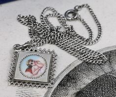 A beautiful genuine vintage Guardian angel medal, petite enamel 800 silver signed German religious lucky charm, fairly rare Guardian angel charm, in good vintage condition. Ideal for protection necklace, would make a nice gift for someone special! Comes with 18 inch long vintage 925 silver necklace (see photo 3)! Material: solid silver Measures: approx. 23 x 23 mm (0.9 x 0.9 inch) A stunning compass jewelry shop well worth a visit ... https://www.etsy.com/shop/TheCompassCollector PLEASE LOOK AT Vintage White Charm Necklaces, Vintage White Gold Necklaces With Vintage Charm, Vintage White Gold Nickel-free Necklace, White Gold Vintage Necklace With Vintage Charm, Vintage Silver Locket Charm Necklace, Vintage Silver Charm Necklace With Locket, Vintage Silver Locket Charm Necklaces, Vintage Silver Charm Necklaces As Gifts, Silver Vintage Charm Necklaces For Gifts