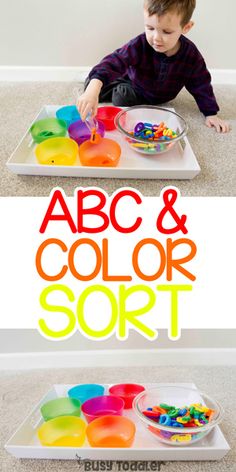 a young boy is sitting on the floor and playing with his colorful sorting trays