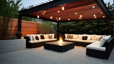 an outdoor living area with couches and fire pit