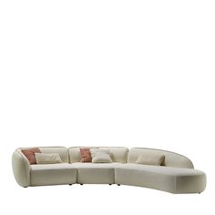 a white couch with pillows on it sitting in front of a white wall and floor