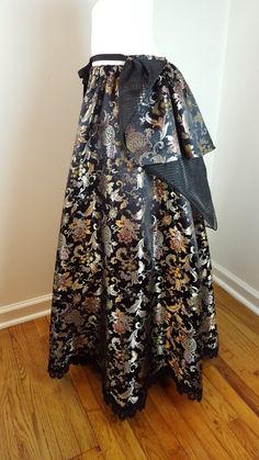 "This one of a kind statement-making ball skirt is very versatile and can be worn for many occasions, such as weddings, proms, Renaissance faires, and Steampunk events. It is made of luxurious Chinese satin brocade in hues of black, gold, red and purple with a scalloped edge lace hemline. The Chinese characters woven into the fabric translate to \"longevity and prosperity\" Please note that this skirt is pictured with a crinoline underneath which is not included. The skirt can easily accommodate Elven Clothing, Chinese Brocade, Victorian Skirt, Pixie Outfit, Steampunk Skirt, Grunge Skirt, Indian Skirt, Ball Skirt, Fairy Skirt