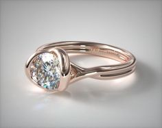 a gold ring with a white diamond in the center