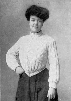 an old black and white photo of a woman in a skirt holding a suitcase with her hands on her hips