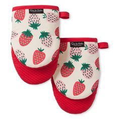 two oven mitts with red and green pineapples printed on the front, one is