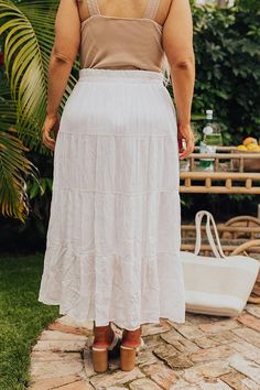 - Pair this flowy skirt with your favorite top for a trendy look! - Partially lined lightweight material with a subtle texture - A stretchy elastic waistband and with a faux drawstring accent - A relaxed silhouette that ends in a straight ankle length hemline Chic White Maxi Skirt With Elastic Waistband, Flowy Drawstring Skirt For Vacation, Flowy Drawstring Skirt For Day Out, White Gathered Maxi Skirt For Day Out, White Bohemian Bottoms With Drawstring, Vacation Tiered Maxi Skirt With Drawstring, Beach Tiered Skirt With Drawstring, White Gathered Skirt For Beach, White Tiered Skirt With Drawstring