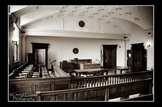 the interior of a church with pews and benches