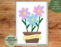 a card with flowers in a pot on top of a wooden table