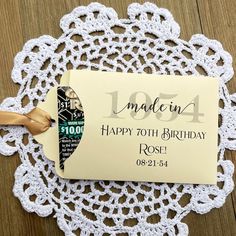 a white doily with a tag on it that says made in 1994 happy 70th birthday rosh