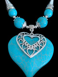 Beautiful Turquoise heart necklace pendant with a lovely silver heart overlay.   Necklace adorned with turquoise and silver beads, with matching heart earrings. Necklace pendant: L55mm x W45mm x D2mm Necklace chain length: 18cm + 7cm extension chain Earring pendants: L20mm X W20mm x D2mm Earring drop length 40mm Earring hooks: Stainless steel - hypo-allergenic Necklace and earrings presented in a lovely black gift box Necklace only: presented in a large black organza bag Earrings only: presented in a small black organza bag Elegant Turquoise Heart Beads Jewelry, Elegant Turquoise Jewelry With Heart Beads, Turquoise Heart Necklace With Heart Beads, Blue Bohemian Heart Pendant Jewelry, Bohemian Blue Heart Pendant Jewelry, Bohemian Turquoise Heart Jewelry, Bohemian Turquoise Jewelry For Valentine's Day, Turquoise Heart Necklace For Valentine's Day, Turquoise Bohemian Jewelry For Valentine's Day