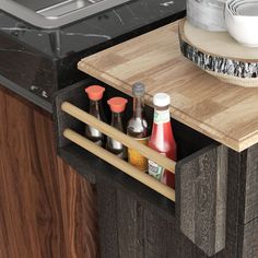 an open drawer with spices and condiments in it next to a counter top