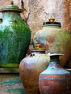 several different colored vases sitting next to each other