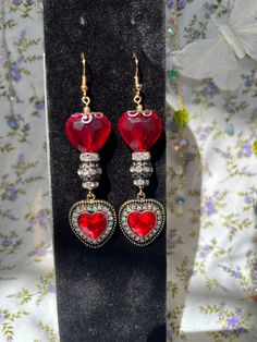 Beautiful double red heart earrings that have a vampire, renaissance/Alice in Wonderland inspired look.  ** While earrings are made to last, they should be treated with care. Not recommended to get wet for long periods of time ** Gothic Party Jewelry With Heart Charm, Gothic Heart Charm Jewelry For Parties, Gothic Heart-shaped Pierced Jewelry, Vintage Red Heart Earrings For Pierced Ears, Red Vintage Heart Earrings, Gothic Dangle Earrings For Valentine's Day, Gothic Dangle Heart Earrings For Gift, Red Gothic Earrings For Pierced Ears, Fantasy Style Pierced Earrings For Party