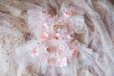 This is a listing for a romper/dress decorated with tulle ruffles with pearls and artificial flowers. Spot clean only, please avoid areas with flowers Sizes: The size is pretty flexible, it ties on the waist back area and it has an elastic.                          12-18 month              Ready to ship! All used materials are new. All items are made with care in a smoke/pet free environment. I would like to invite you to Your Dream Pix LLC VIP customers group!  Please, join us for all news and updates from my shop, new products, SALES and discounts.  https://www.facebook.com/groups/550907811777869/ Thank you! Whimsical Ruffled Tutu Dress For Wedding, Elegant Spring Bubble Romper With Ruffles, Spring Party Bubble Romper With Ruffles, White Ruffled Bubble Romper For Party, Elegant Ruffled Tutu Dress For Birthday, Fitted Bubble Romper With Ruffles For Birthday, Fitted Ruffles Bubble Romper For Birthday, Cute Ruffled Tutu Dress For Wedding, Cute Floral Applique Tutu Dress For Party