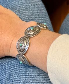 This western bracelet is concho style with little turquoise stones on the cocho for the perfect flair. It is a stretch style so it makes putting it on and off easy. Bracelet is 4" Zinc, brass, rhodium plated, stones lead compliant, nickel free to prevent tarnish. For best results, please avoid wet surfaces. This item is in stock and ready to ship same or next day from our warehouse in Rozet, Wyoming. Southwestern Adjustable Nickel Free Bracelets, Adjustable Turquoise Western Bracelet, Adjustable Stamped Turquoise Bracelets, Adjustable Turquoise Stamped Bracelets, Western Turquoise Bracelets With Concho, Western Turquoise Bracelet With Concho, Western Style Turquoise Bracelet With Concho, Nickel Free Adjustable Southwestern Cuff Bracelet, Adjustable Turquoise Cuff Bracelet With Concho