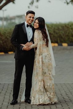 a bride and groom pose for a wedding photo