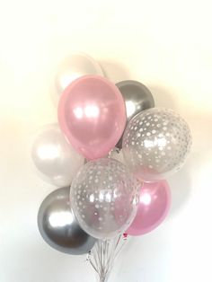 a bunch of balloons that are in the shape of polka dots on a white background