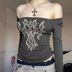 This top marries the raw energy of grunge with avant-garde aesthetics, showcasing a striking bleached cross motif. A true statement piece, its fitted silhouette and eye-catching design make it a bold choice for anyone looking to channel an edgy, artistic vibe. A prime pick for fashion-forward individuals. Grunge aesthetic Bleached design Square neck Long sleeve Also usable off-shoulder Polyester, spandex Grunge Cross, Grunge Jacket, Artistic Vibe, Crop Pullover, Geometric Sleeve, Shiny Pants, Retro Tops, Aesthetic T Shirts, 90s Streetwear